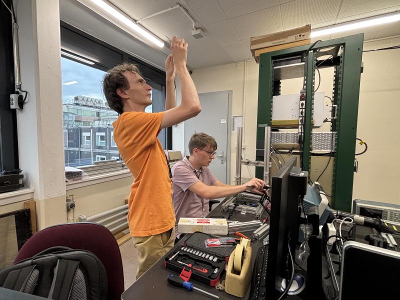 Graduate student Stahlhut and master's student Grande preparing the quartz Cherenkov-based trigger cross ahead of the test beam, in 251 ATLAS FWD Lab at CERN.